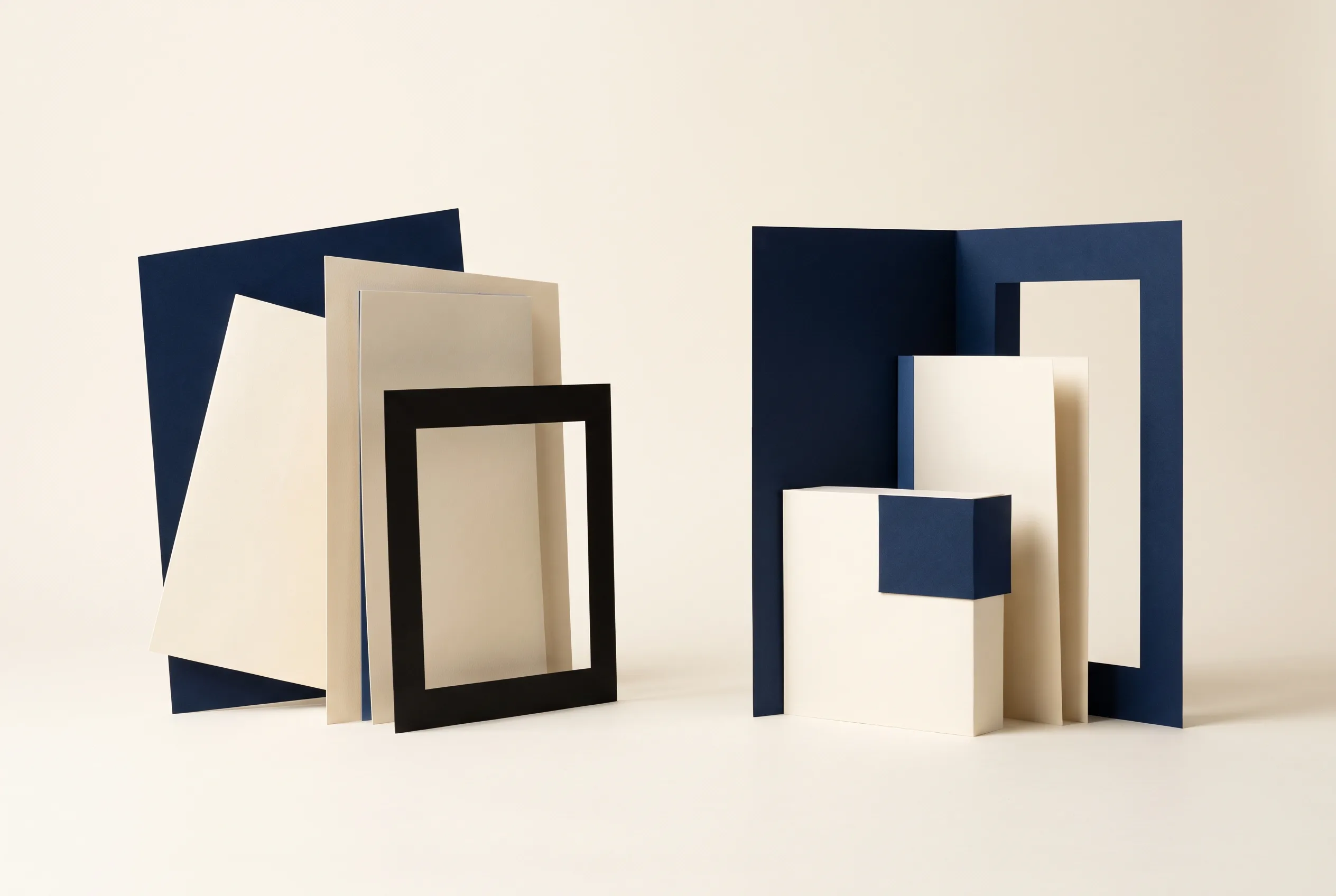 Abstract editorial composition of architectural forms arranging themselves in navy, black, and ivory